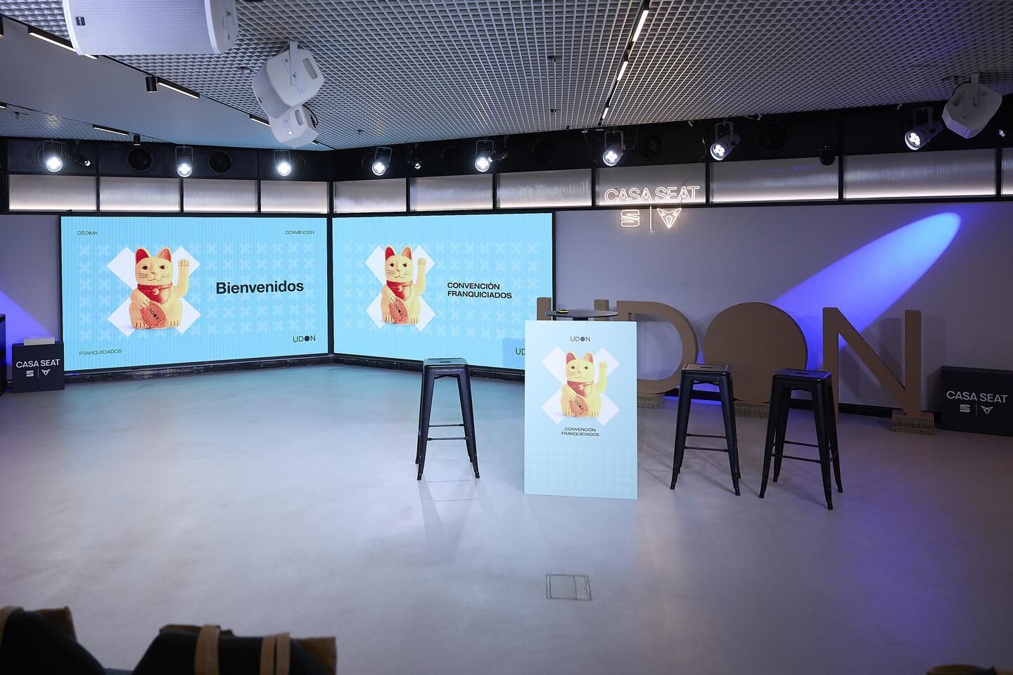 Stage set for Udon's Franchisee Convention at Casa Seat, with the lucky cat and the X as the event's graphic elements