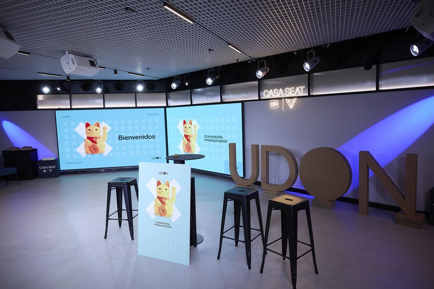 Stage set for Udon's Franchisee Convention at Casa Seat, with the lucky cat and the X as the event's graphic elements